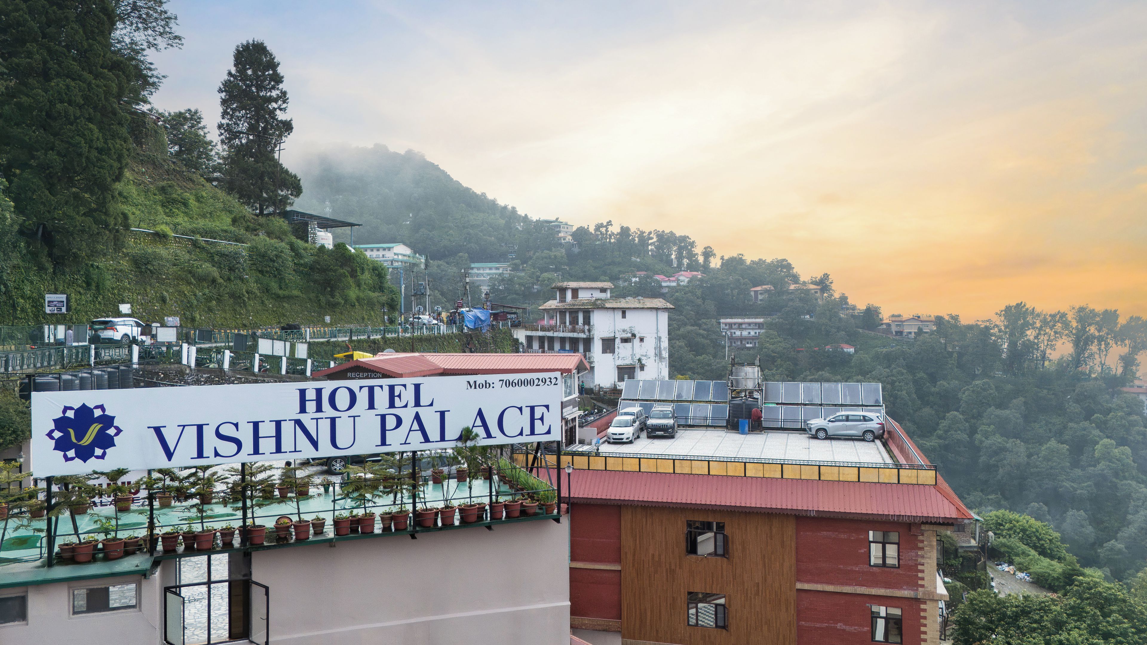 A hotel named Vishnu Palace with a rooftop garden and solar panels.