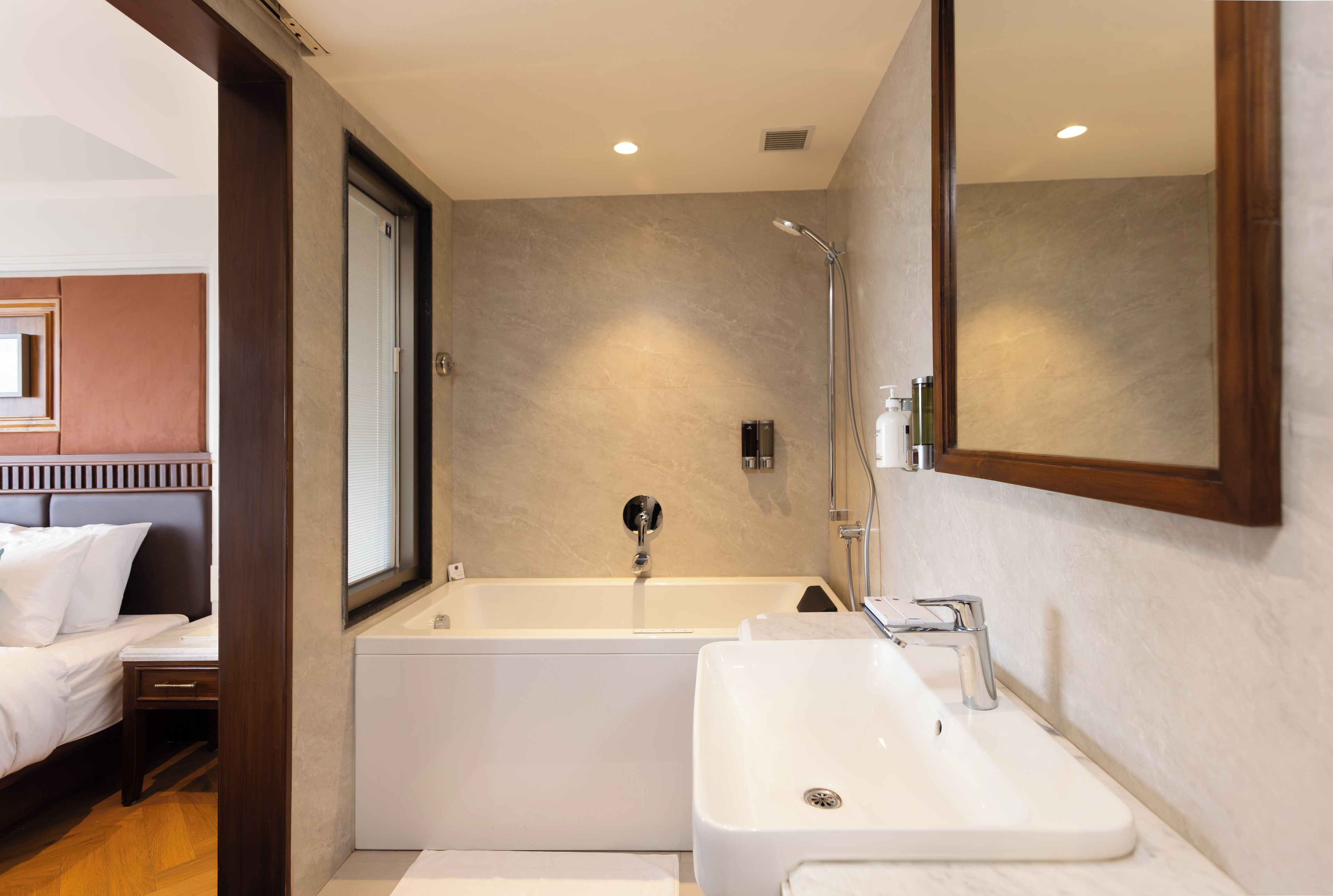 A modern bathroom with a bathtub, a sink, and a shower.