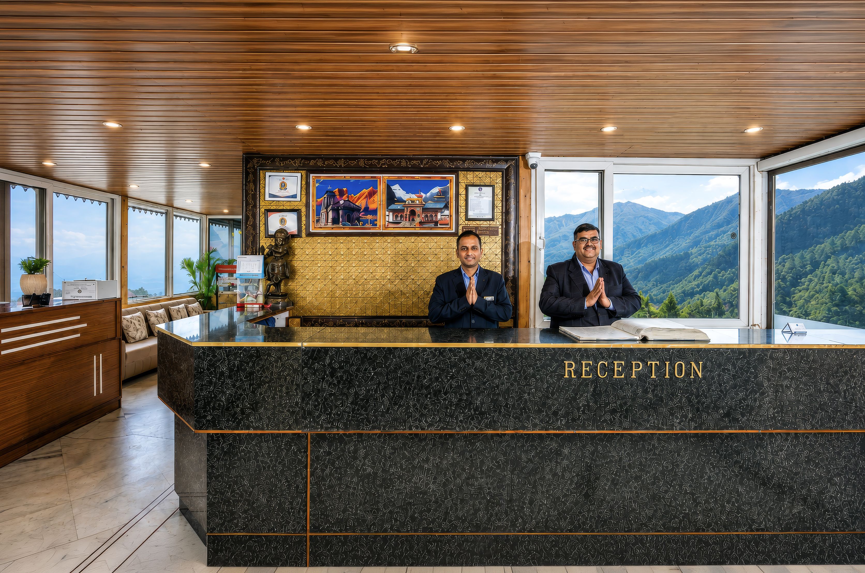 A reception desk with a view of mountains, two staff members, and a framed certificate on the wall.