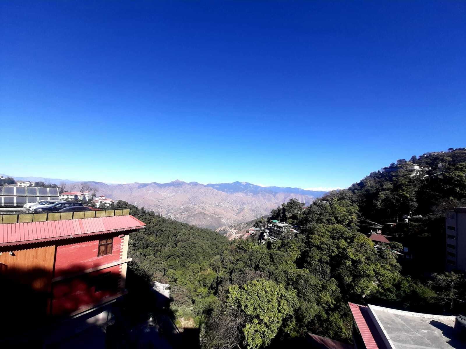 A mountainous landscape with a clear blue sky.