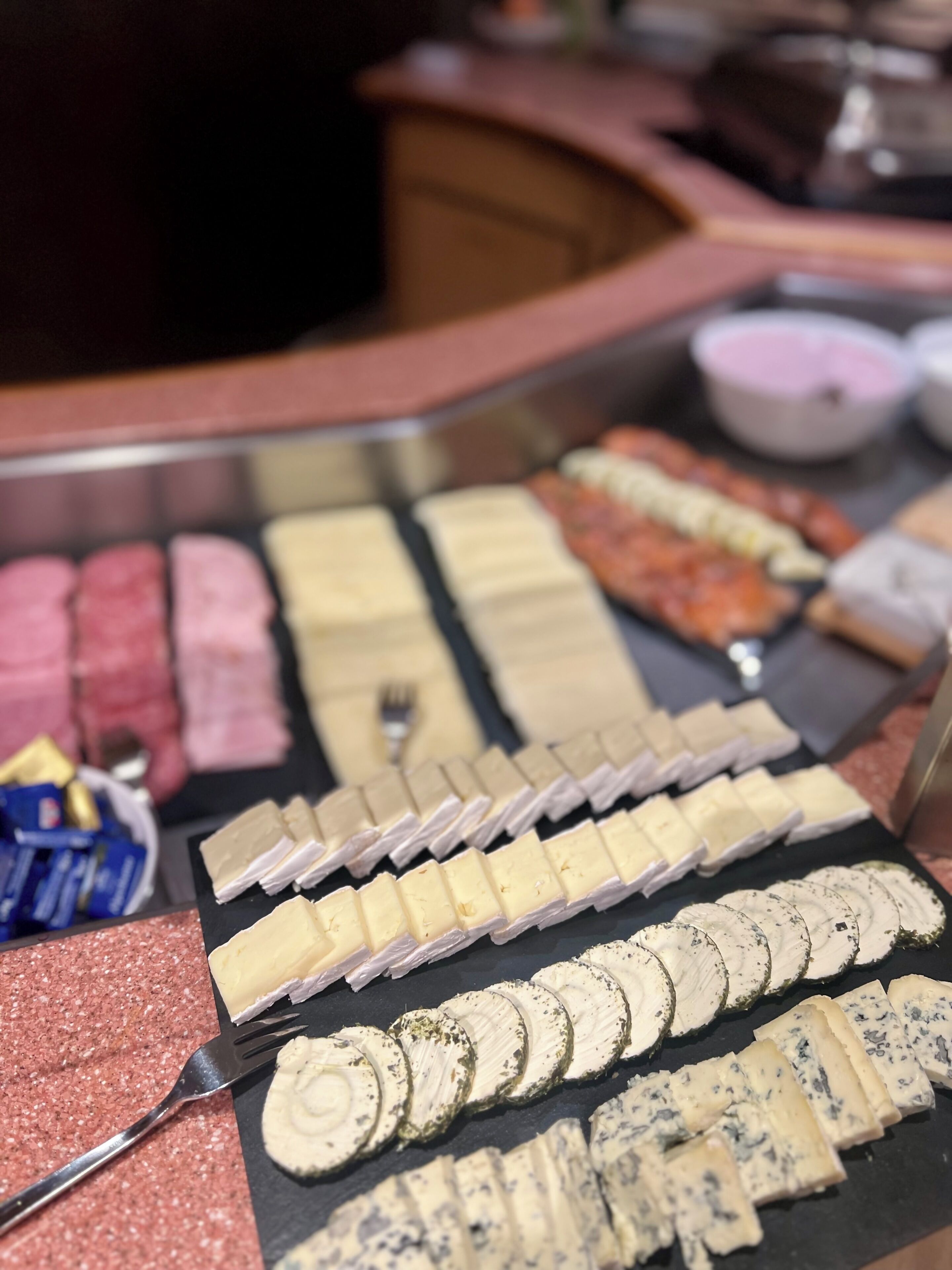 A variety of cheeses and crackers arranged on a table.