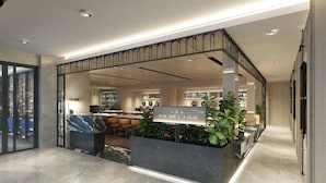 A modern hotel lobby with a reception desk, seating area, and potted plants. - Citadines Connect Bertam Georgetown Penang (George Town)