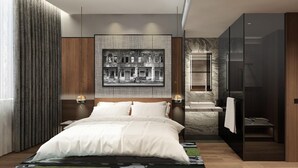 A modern bedroom with a large bed, a headboard with integrated lighting, a wall-mounted artwork, a separate bathroom with a marble sink, and a sliding door closet. - Citadines Connect Bertam Georgetown Penang (George Town)