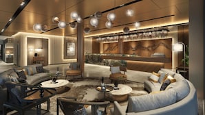 A modern lounge area with sofas, armchairs, and a bar area with a marble countertop and hanging glasses. - Citadines Connect Bertam Georgetown Penang (George Town)