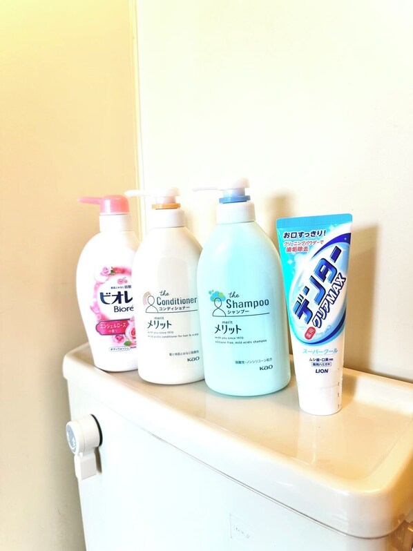 Toiletries on a toilet tank.