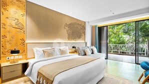 A modern bedroom with a large bed, a wooden headboard with carvings, a view of lush greenery through large windows, and a balcony with a railing. - Moriya by Kozystay - Nusa Dua (Nusa Dua)