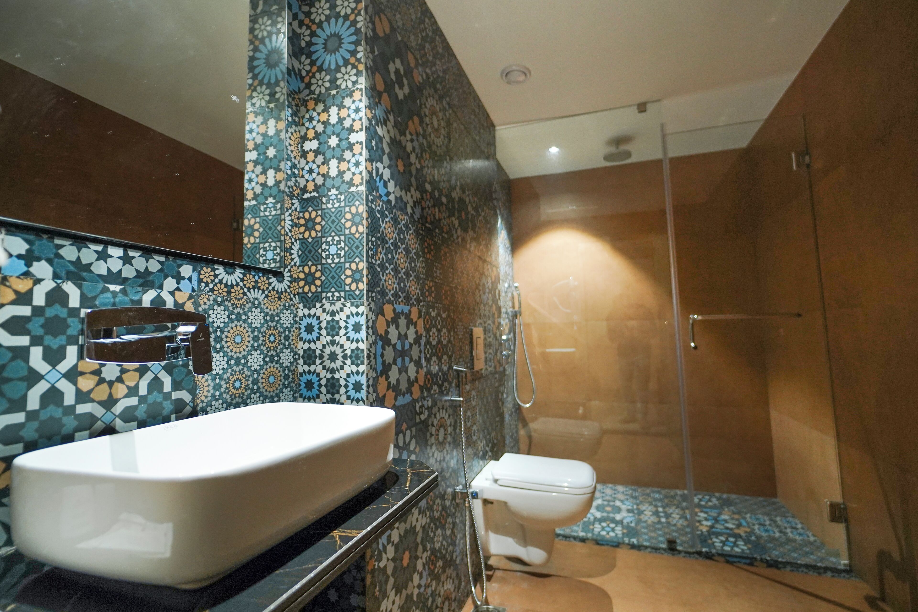 A bathroom with a white sink, a toilet, and a shower area.