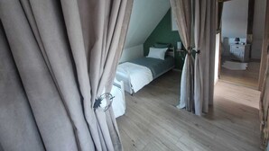 A bedroom with a bed, a bedside table, and a nightstand.