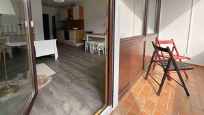 A modern apartment with a kitchen, dining area, and a balcony with outdoor furniture. - Renovated loft with parking space and balcony (Lörrach)