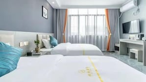 A hotel room with two beds, a desk, a TV, and a large window with curtains. - Panda House Hotel (Chengdu)