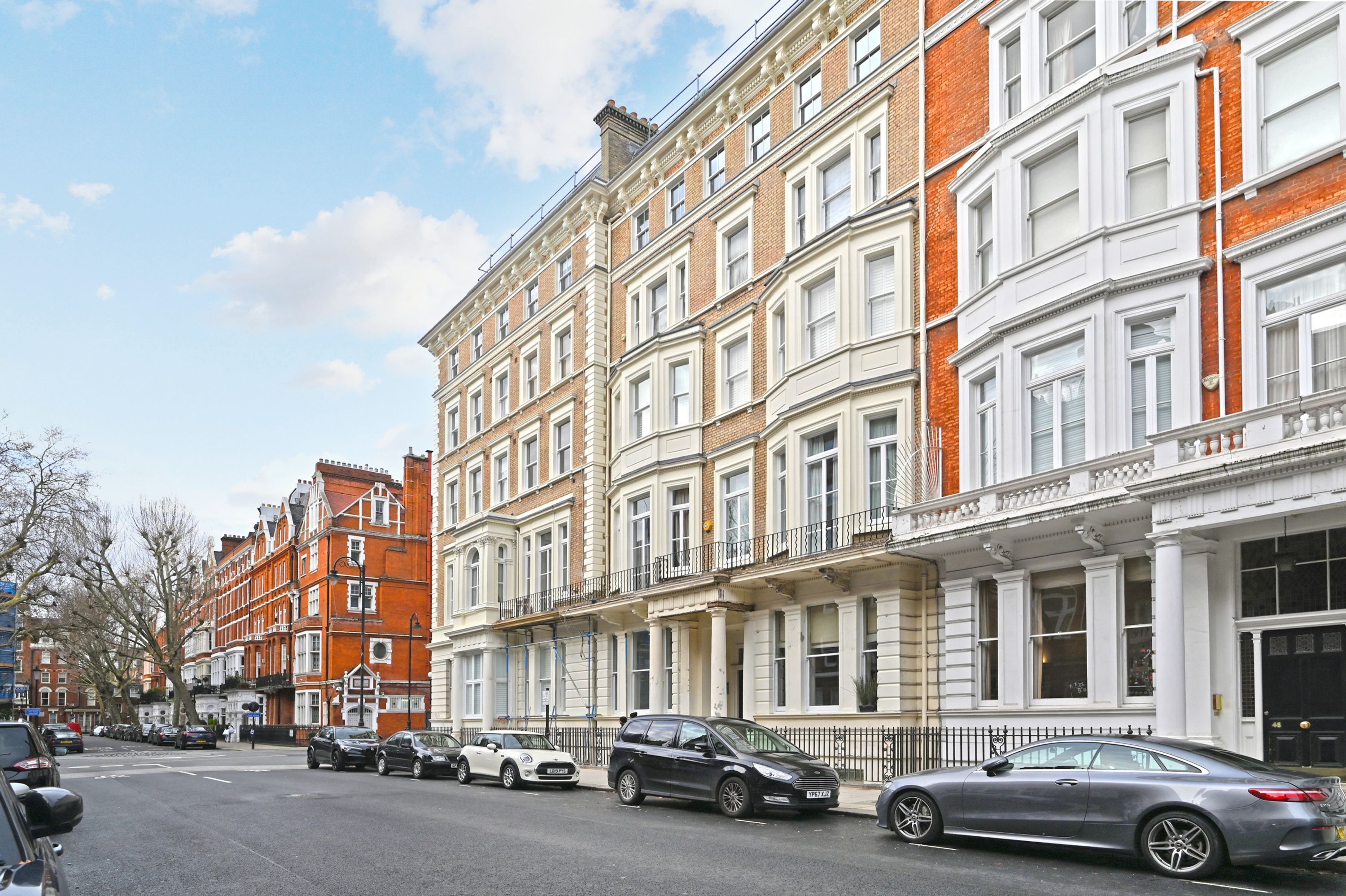 A row of terraced houses with a street in front.