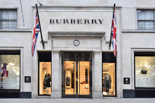 A Burberry storefront with large glass windows displaying clothing.