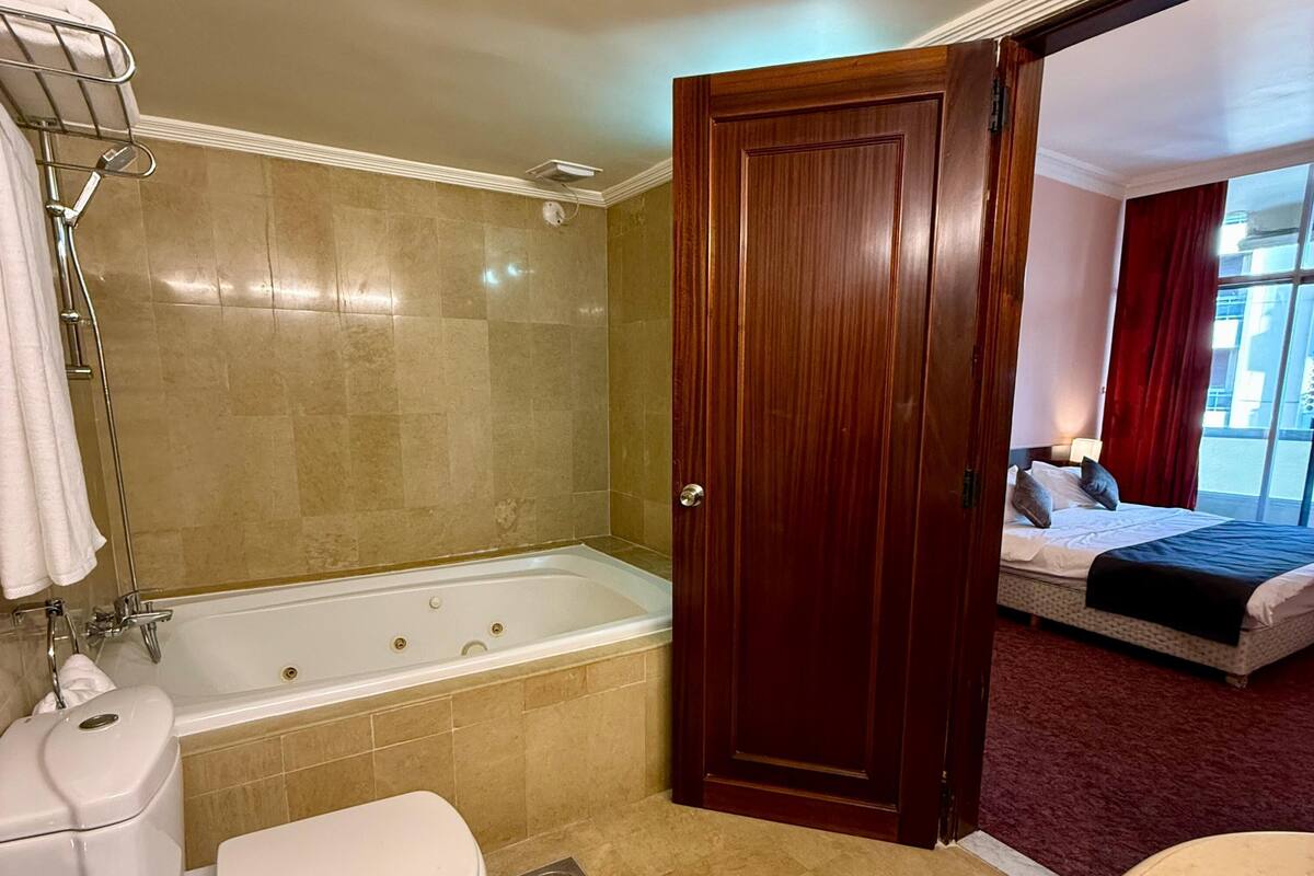 A bathroom with a bathtub, toilet, and sink.
