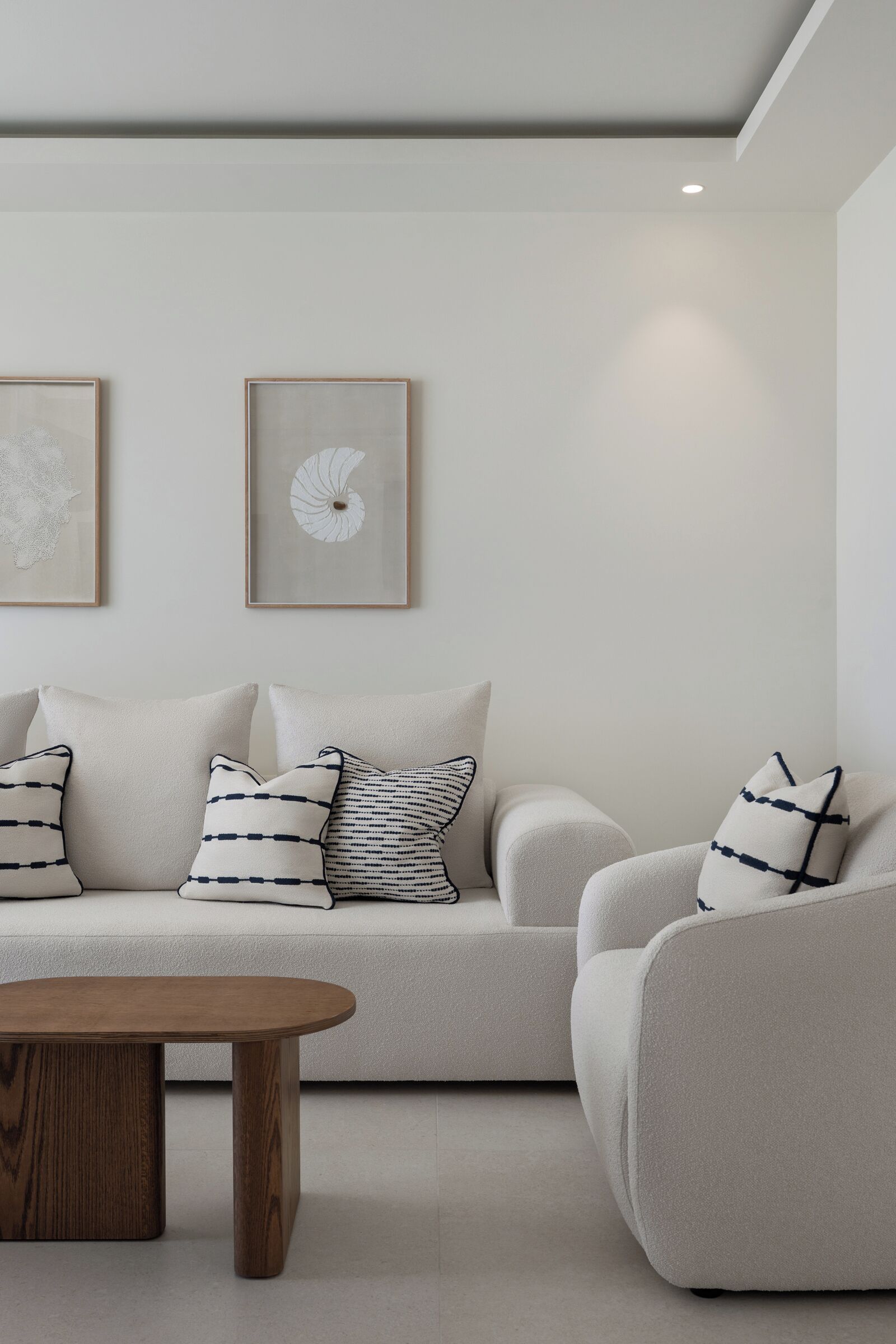 A modern living room with a sofa, armchair, and coffee table.