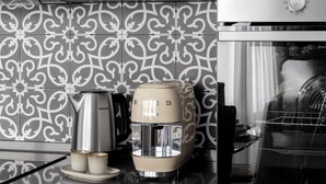 A kitchen with a coffee maker, a kettle, and a toaster on the counter. - "LE DUE CUPOLE" LUXURY APARTMENT "A" IN THE CENTER OF ROME (Roma)