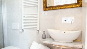 A bathroom with a white sink, a toilet, and a shower. - The Railway 74 (La Spezia)
