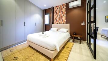A modern bedroom with a large bed, a wardrobe, and a small bedside table.