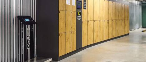 A luggage storage area with numbered lockers and a luggage scale.