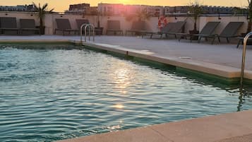 Seasonal outdoor pool, open 11:00 AM to 9:00 PM, sun loungers