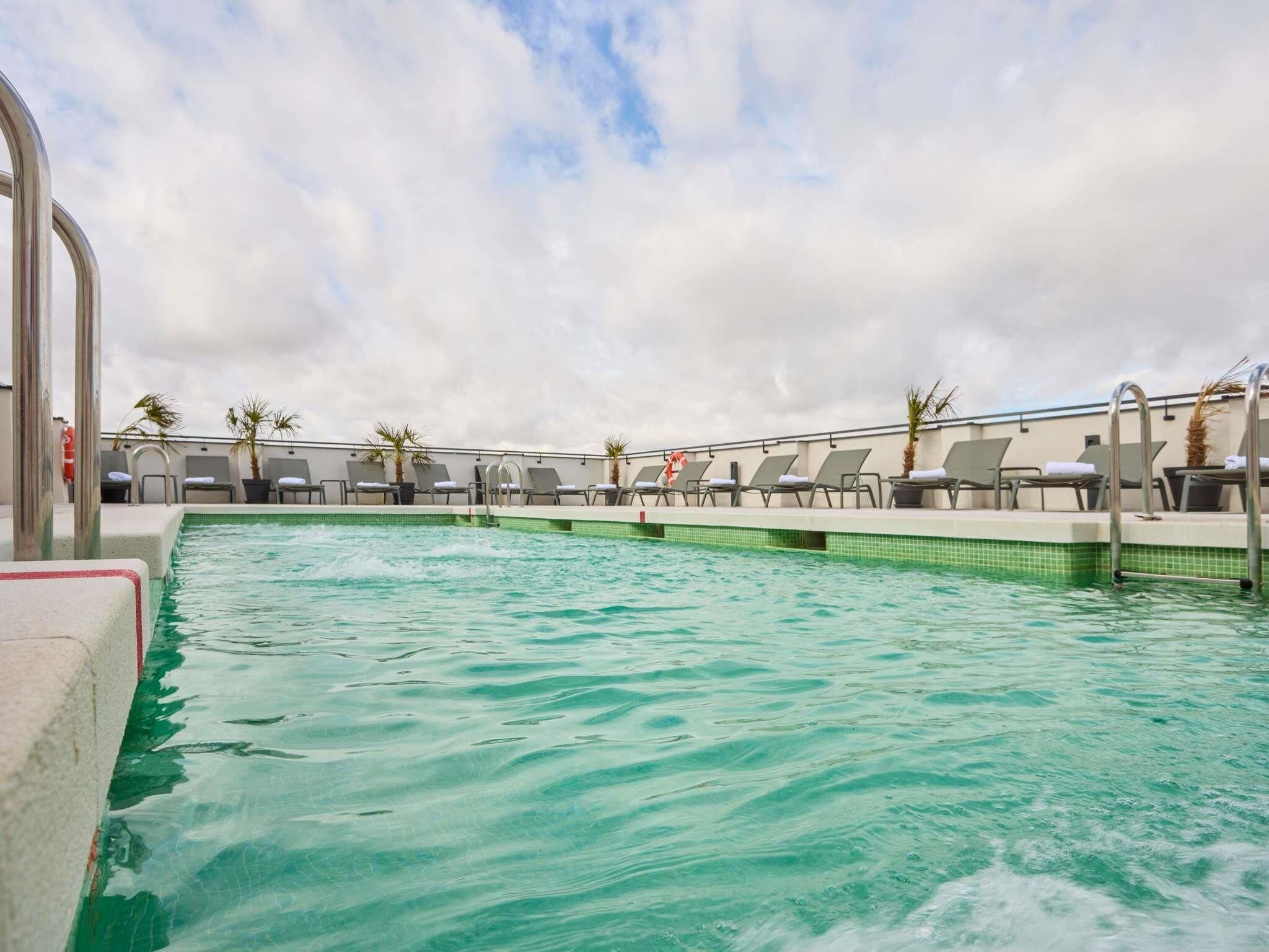 Seasonal outdoor pool, open 11:00 AM to 9:00 PM, pool loungers