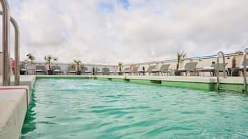 Seasonal outdoor pool, open 11:00 AM to 9:00 PM, pool loungers