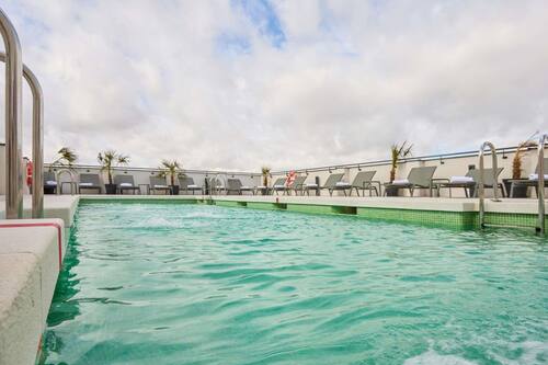 Seasonal outdoor pool, open 11:00 AM to 9:00 PM, pool loungers