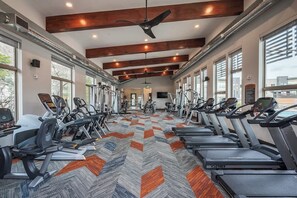 A gym with treadmills, ellipticals, and weight machines.