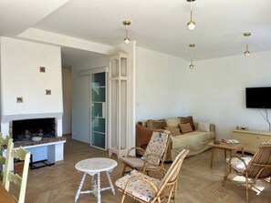 A living room with a fireplace, a sofa, and a television.