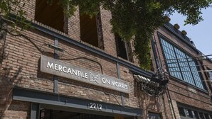 A brick building with a sign that reads "Mercantile on Morris" and the address "2212". - #302 New Downtown Condo on Morris Ave (Birmingham)