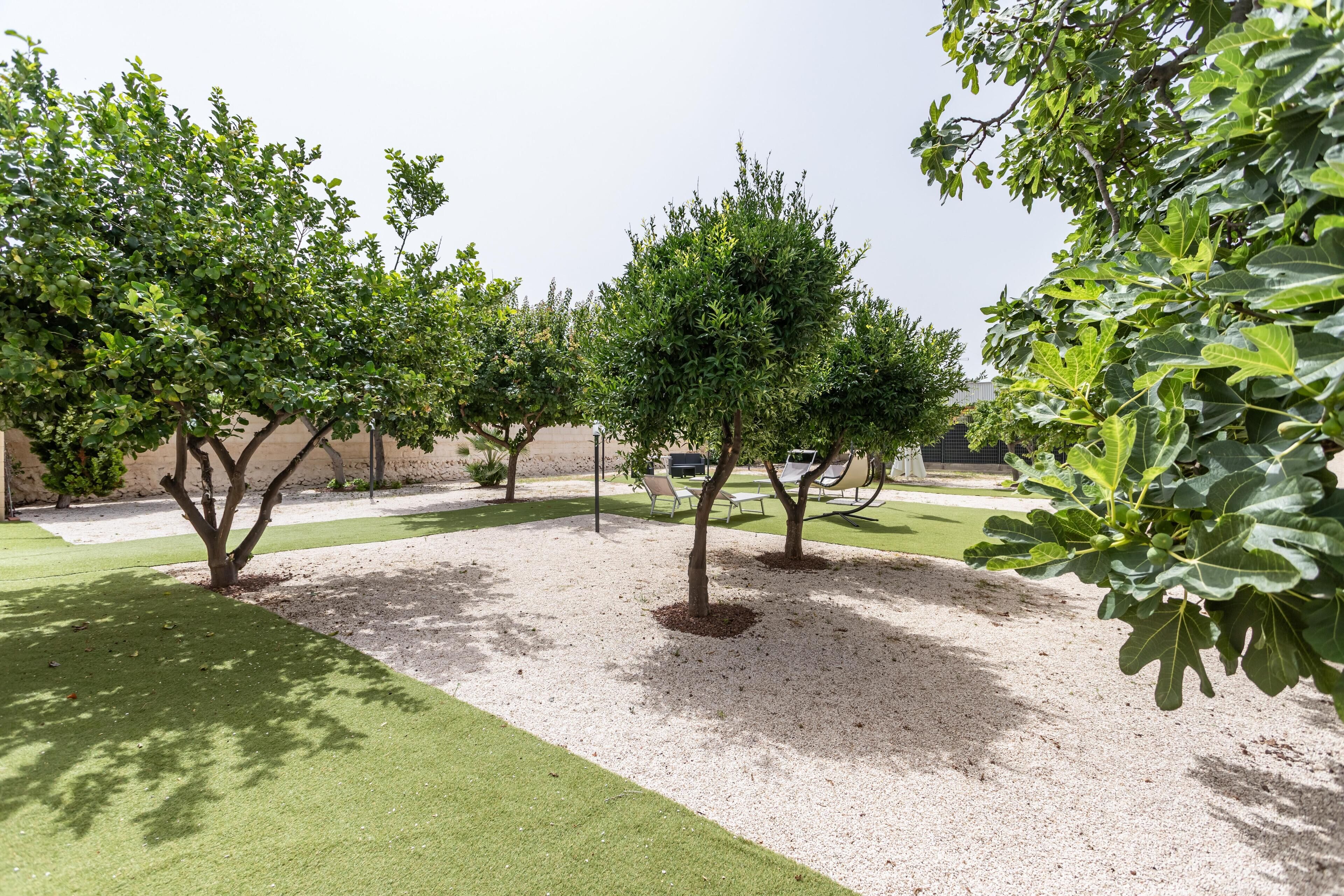 A landscaped garden with trees and a gravel path.