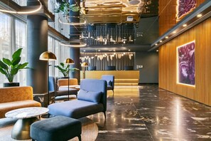 Welcome to our lobby, featuring a reception desk, comfortable seating, and polished floors.