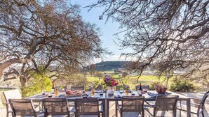 An outdoor dining area with a table set for six, surrounded by chairs, overlooking a scenic landscape. - Cathedral by Avantstay Charming Secluded Estate w Sauna Pool Table Views of the Rolling Hills (Templeton)