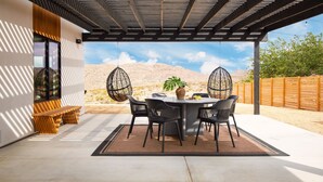 An outdoor patio with a round table, chairs, and a bench. - Chicory by Avantstay Modern Desert Retreat w Hot Tub (Joshua Tree)