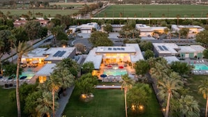 An aerial view of a resort with multiple buildings, a swimming pool, and palm trees. - Polo Villa 7 by Avantstay Features Entertainer s Backyard Game Room 260316 5 Bedrooms (La Quinta)