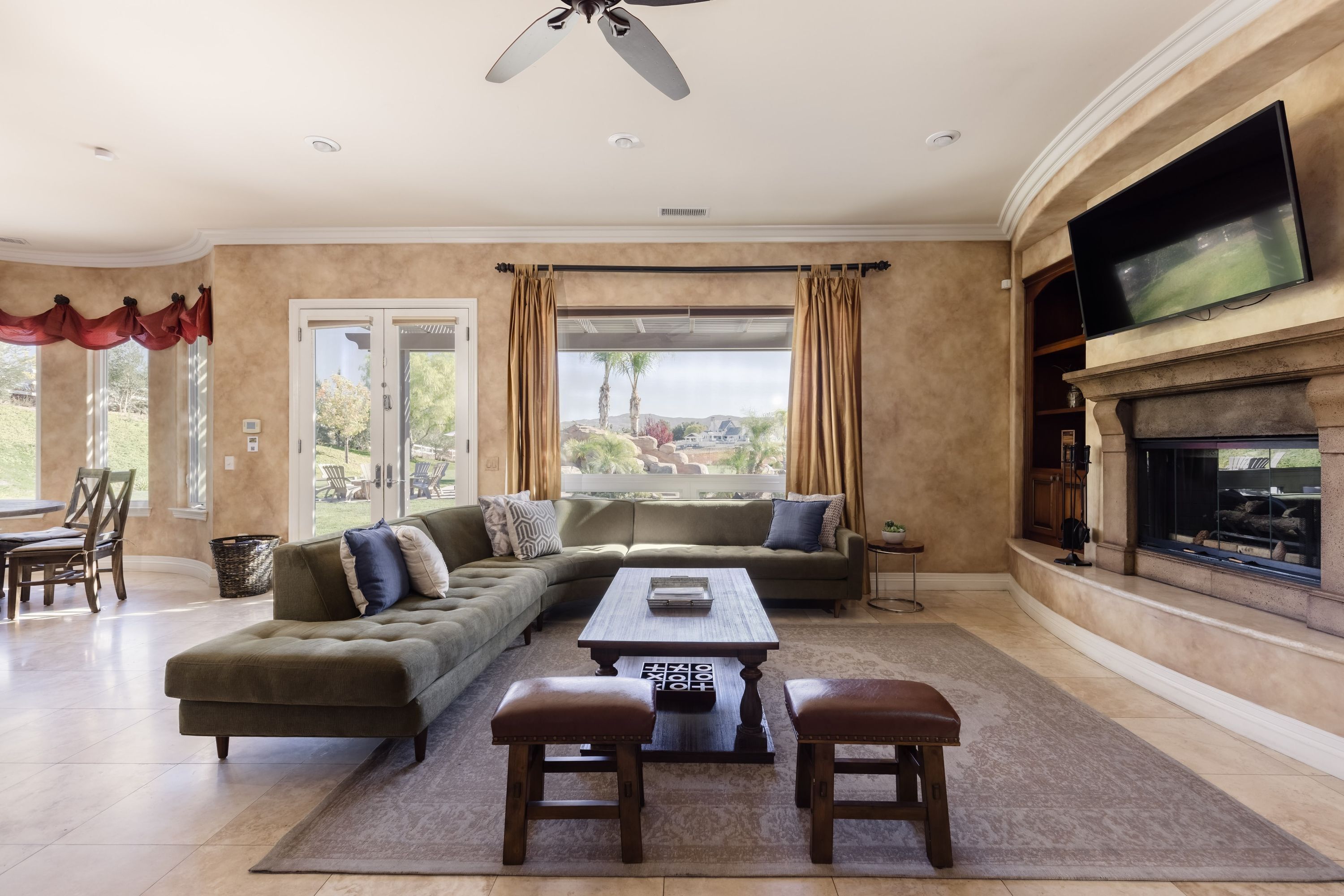 A living room with a sectional sofa, a coffee table, and a fireplace.