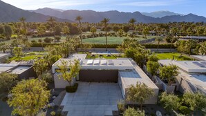 A modern hotel with a rooftop terrace, surrounded by palm trees and mountains. - Polo Villa 2 by Avantstay Entertainer s Backyard w Pickleball Court Pool Spa 260314 6 Bedrooms (La Quinta)