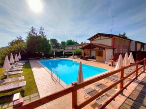 Seasonal outdoor pool, open 10:00 AM to 8:00 PM, pool umbrellas
