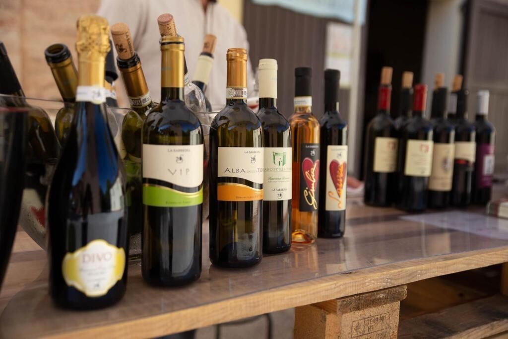 A variety of wine bottles displayed on a wooden table.