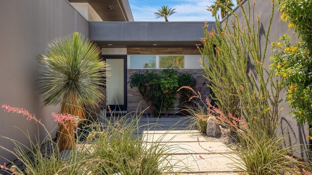 A modern outdoor patio with a variety of plants and a minimalist architectural design. - Polo Villa 6 by Avantstay Features Expansive Putting Green Pool Spa Outdoor Firepit 260324 5 Bedrooms (La Quinta)