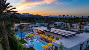 A modern resort with multiple buildings, a swimming pool, and outdoor seating areas. - The Reserve at Polo Villas 15 by Avantstay (La Quinta)