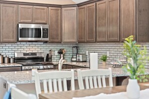 Enjoy cooking in this well-equipped kitchen with a microwave, oven, and ample storage.