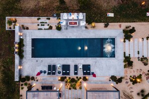 An aerial view of a swimming pool area with lounge chairs, a fire pit, and surrounding landscaping. - Marquee By Avantstay Modern Stylish Estate w Pool Entertainers Courtyard (Sonoma)