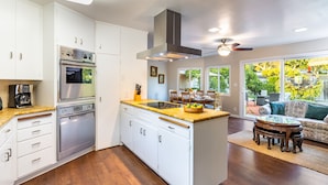 A modern kitchen with white cabinets, stainless steel appliances, and a large island. - East Valley Manor by Avantstay Minutes to the Beach (Santa Barbara)
