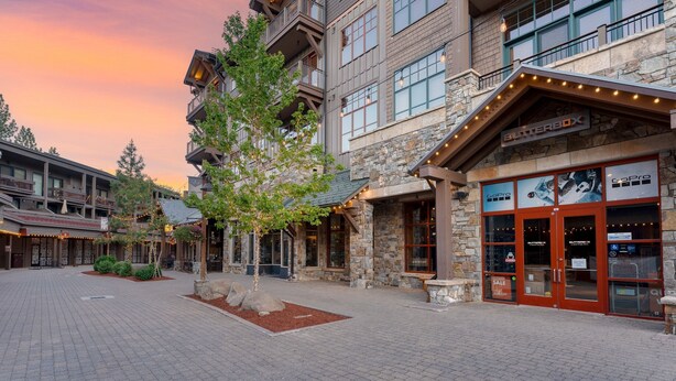 A multi-story building with a stone facade, large windows, and a sign for 'Butterbox'.