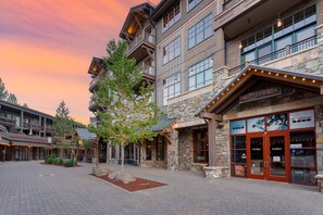 A multi-story building with a stone facade, large windows, and a sign for 'Butterbox'. - Village Studio by Avantstay Minutes to Lifts (Truckee)