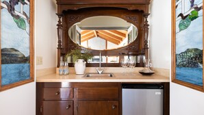 A kitchen with a wooden cabinet, a stainless steel refrigerator, a sink, and a mirror above it. - Wildflower by Avantstay Gorgeous Wine Country Home w Pool Bocce Ball Court Huge Yard (Sonoma)