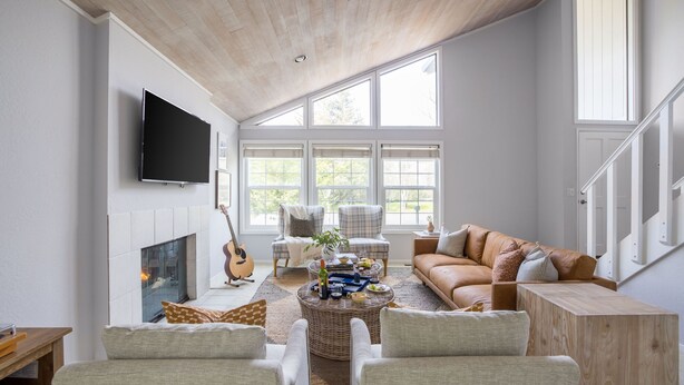 A spacious living room with a fireplace, comfortable seating, and large windows. - Black Oak by Avantstay Modern Chic Santa Rosa Hideaway With Pool Table Fire Pit (Santa Rosa)