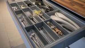 A drawer with compartments containing various kitchen utensils and tools. - Quiet apartment for commuters & nature lovers - parking lot (Duisburg)