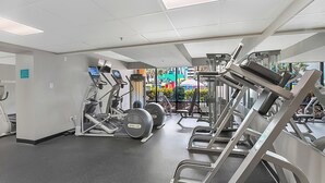 A gym with treadmills, weight machines, and a mirrored wall. - Caravelle Resort 606 (Myrtle Beach)