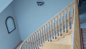 A staircase with wooden balusters and a handrail. - Tower House
 (Helen's Bay)